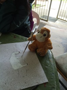 Painting a design for the poop project merchandise